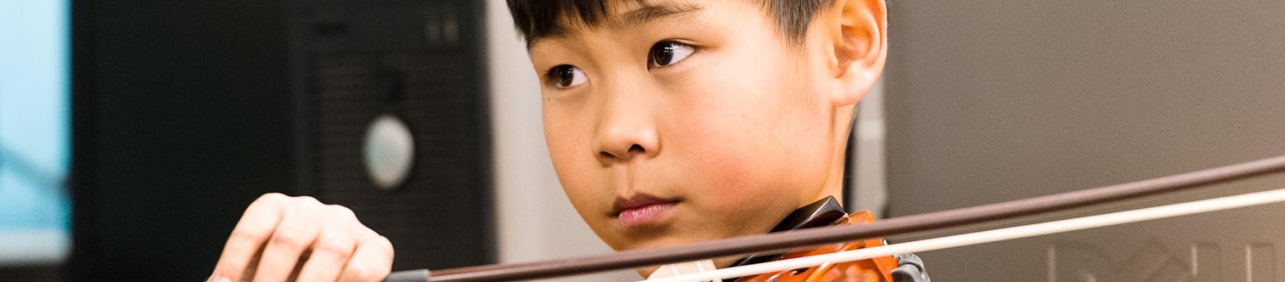 Boy focused with violin